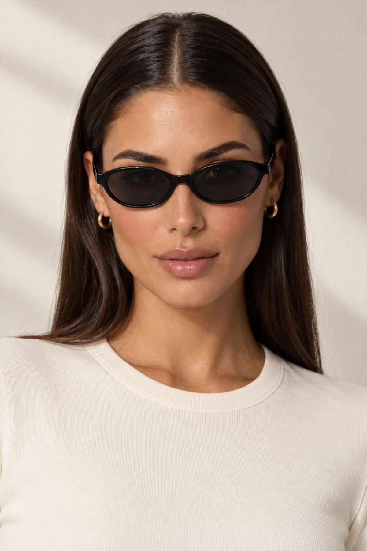 Fedevie model wearing black small oval sunglasses, front view