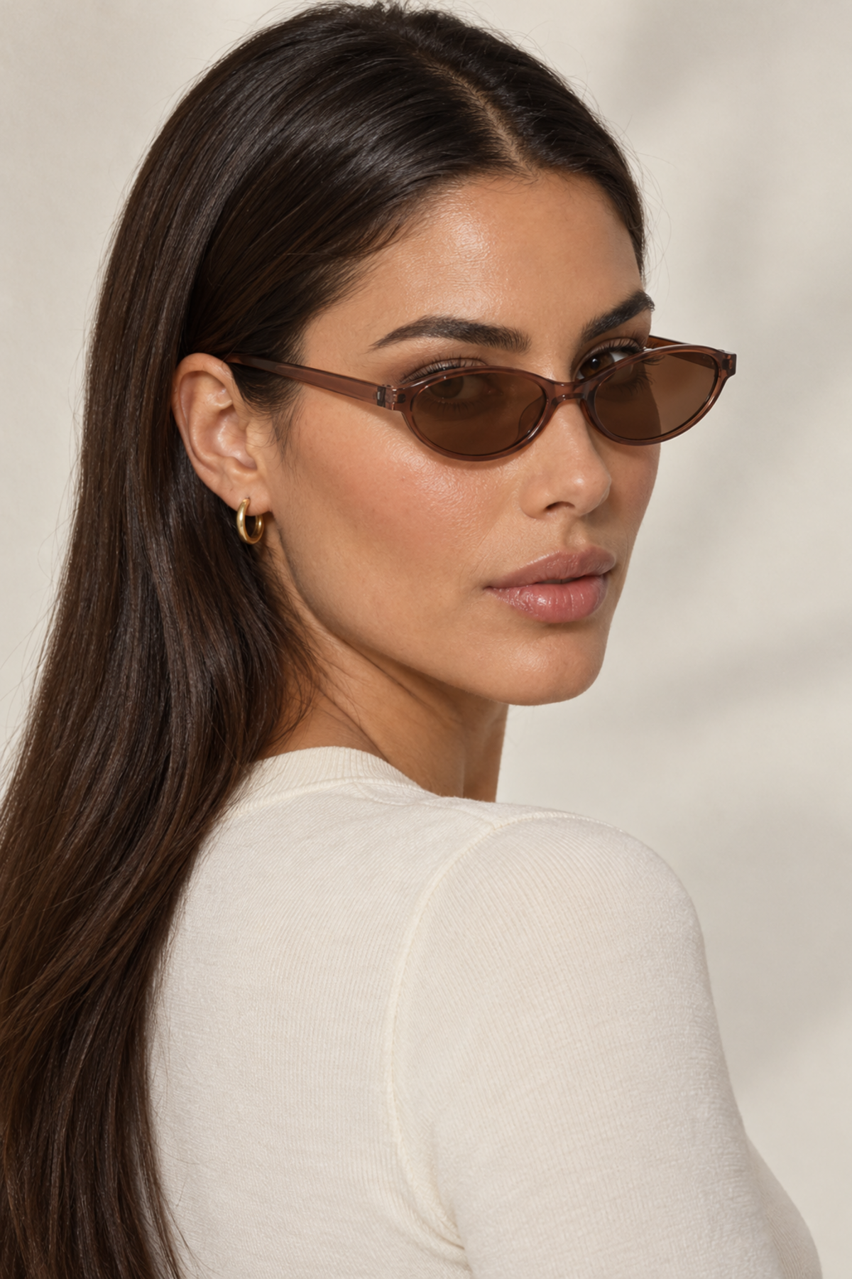 Fedevie model wearing Brown small oval sunglasses, rear three-quarter view