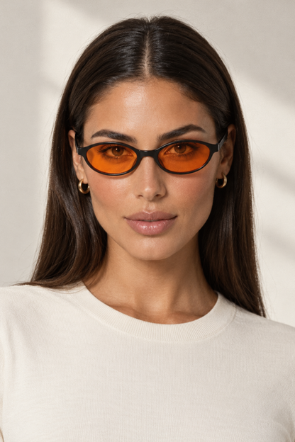 Fedevie model wearing Orange small oval sunglasses, front view