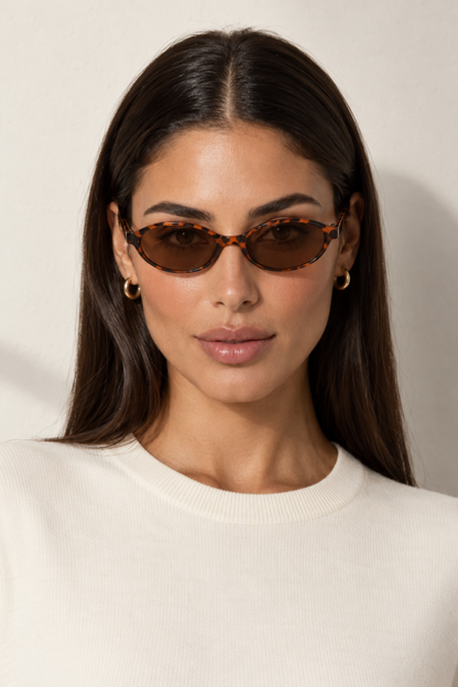 Fedevie model wearing tortoiseshell small oval sunglasses, front view
